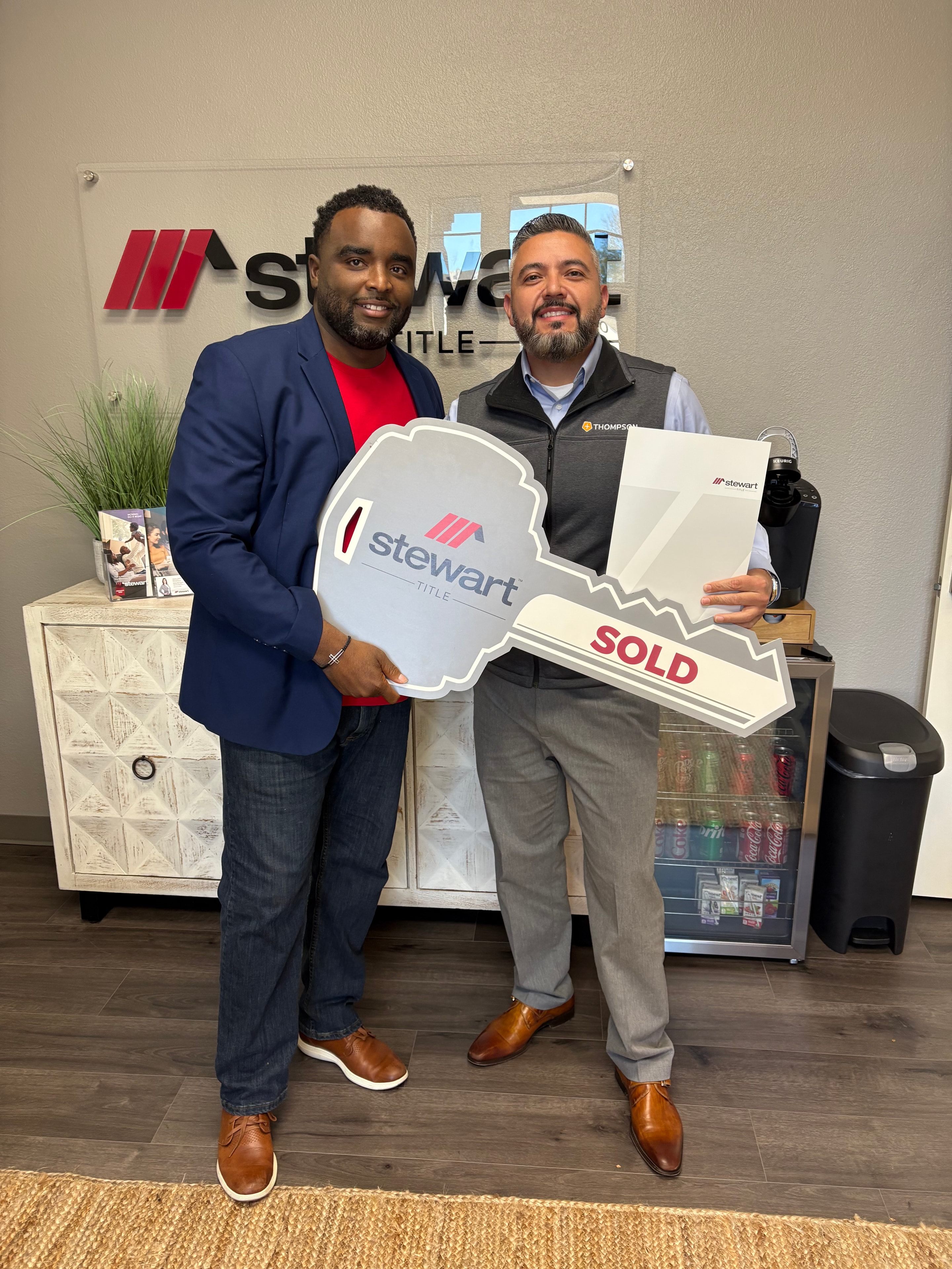 Byron Haynes celebrating a home sale with clients at Stewart Title